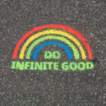 Rainbow in chalk with the words: do infinite good written below