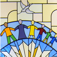 Stained glass of people holding hands with a dove overhead