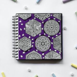 zentangles in a notebook, surrounded by chalk