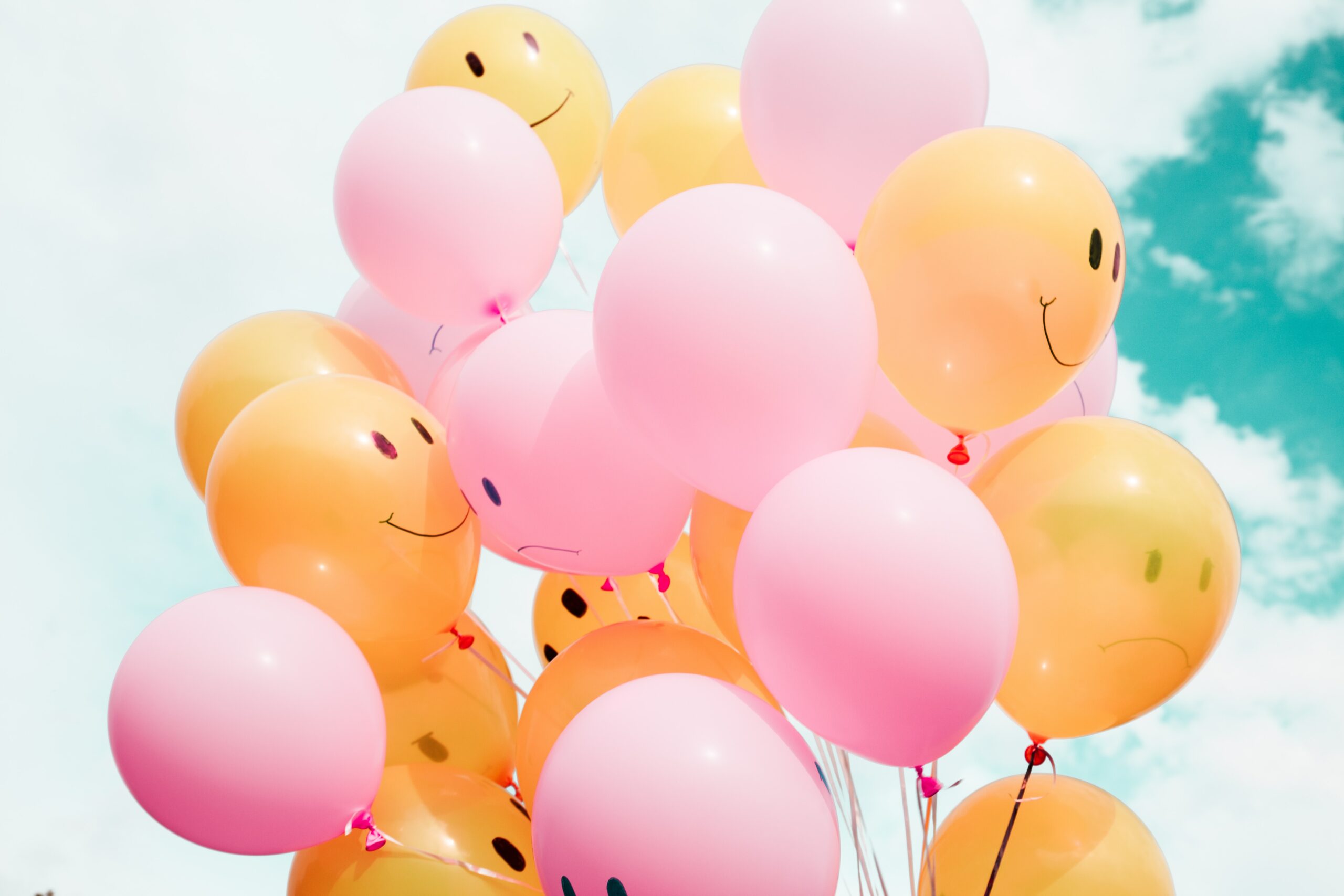 balloons with happy and sad faces